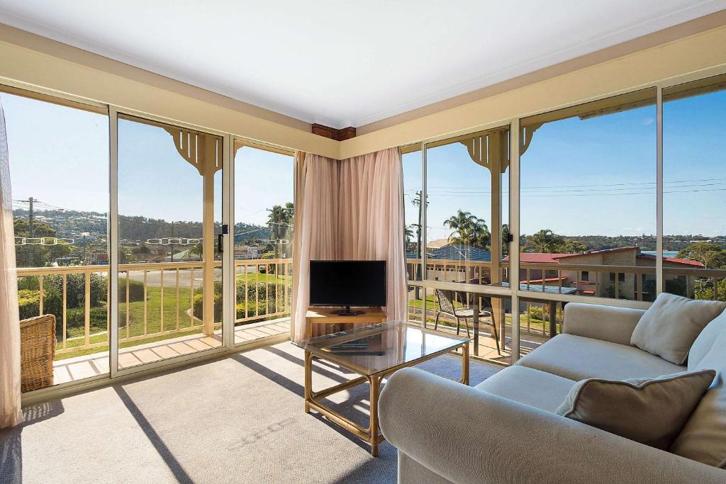 Spacious guest lounge with sofa and panoramic balcony views