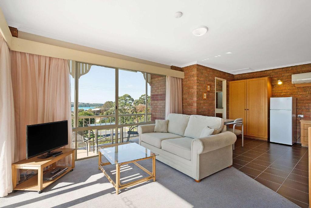 Living area with sofa bed, kitchenette and lake views