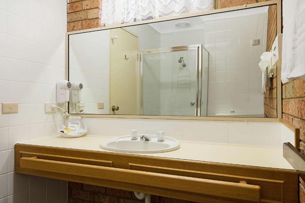 Guest bathroom with shower, vanity and hair dryer